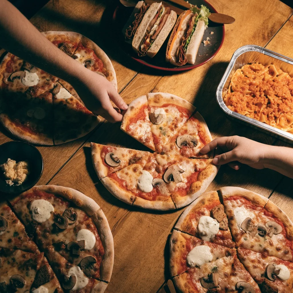 Pizza boxes sliding across the counter for pickup