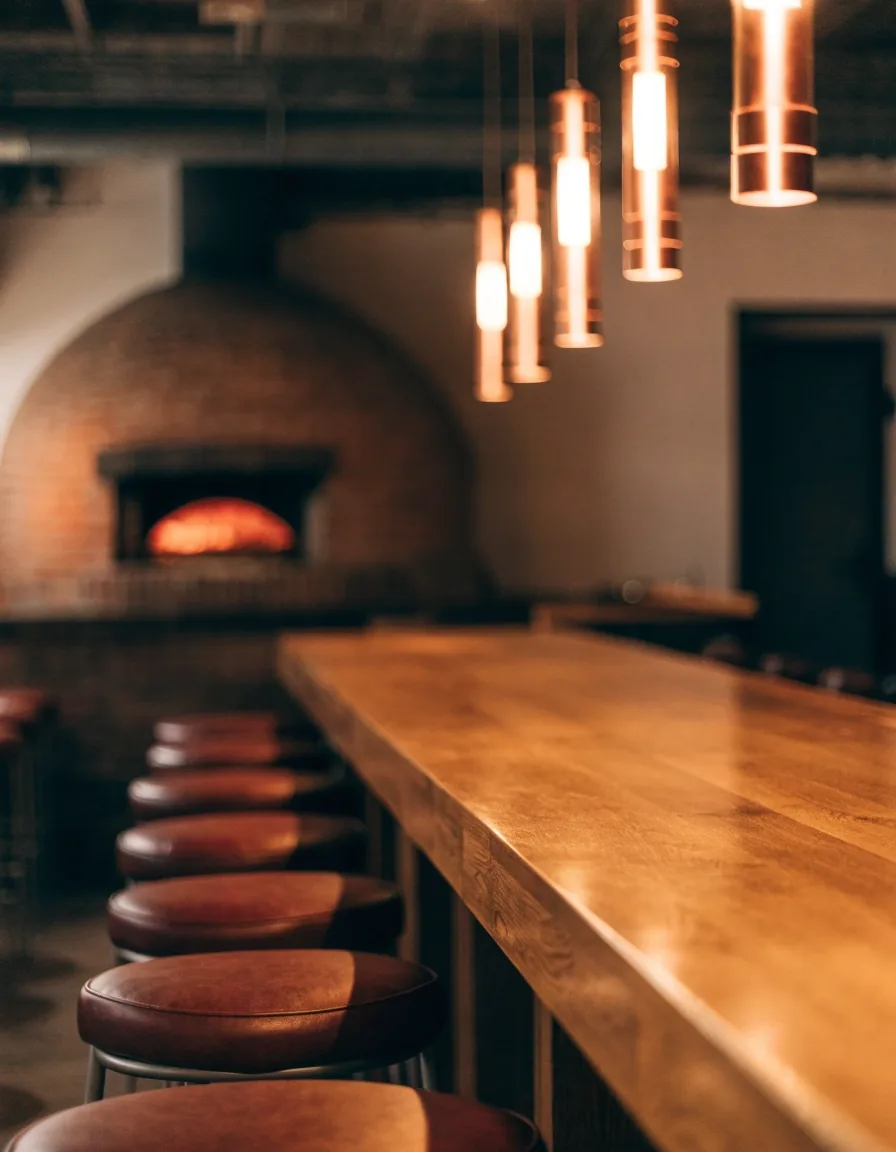 Warm dining counter with stools under pendant light